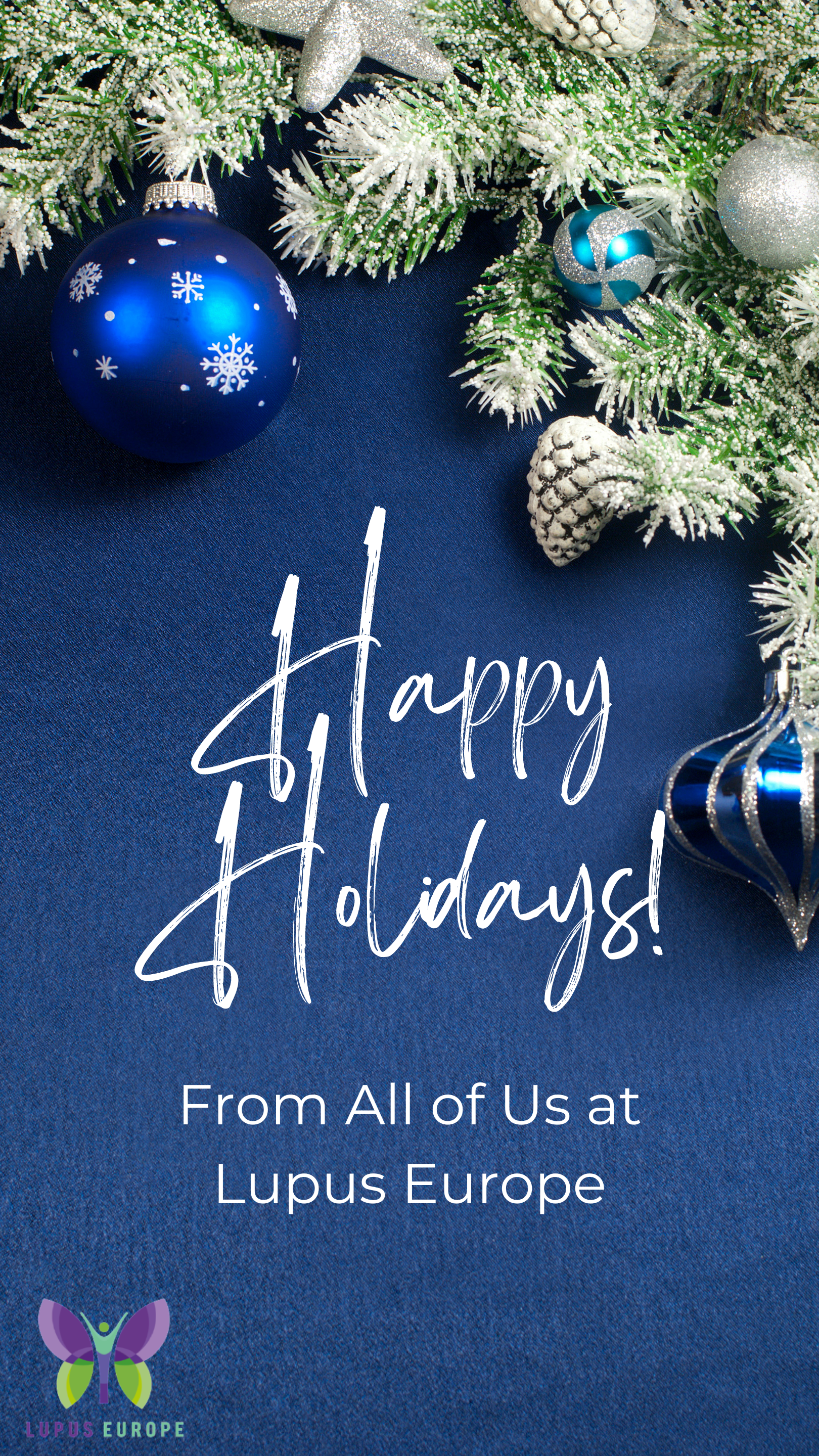 Happy Holidays greeting with a blue Christmas ornament and frosted pine branches on a navy blue background, from Lupus Europe.