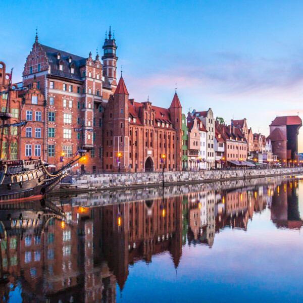 Sunset view of the Motlawa River embankment with historical buildings in Gdansk, Poland.